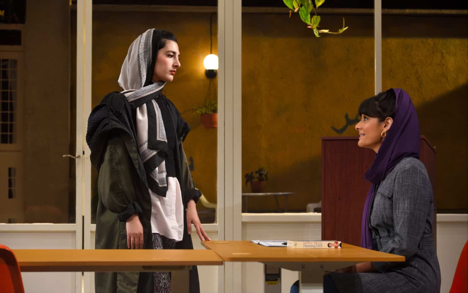 Sanaz Toossi, playwright and actor, speaks as Elham, a student holding eye contact with her teacher, Nazanin Nour as Marjan, in Toossi's nationally awardwinning play 'English' at Barrington stage. Press photo courtesy of BSC