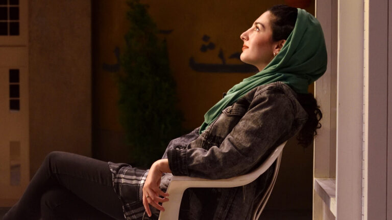 Sanaz Toossi, playwright and actor, looks up into the light as Elham, a student in Iran, in her play 'English' at Barrington stage. Press photo courtesy of BSC