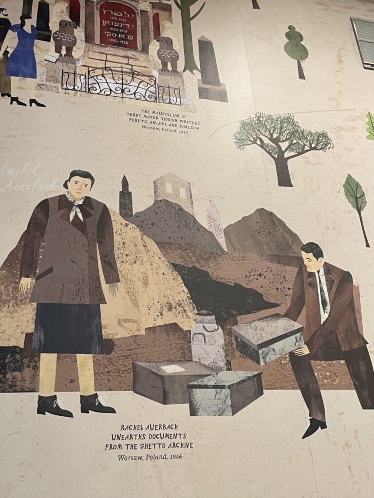 In a mural showing the global reach of Yiddish, Rachel Auerbach unearths documents from the Ghetto archive. Press photo courtesy of the Yiddish Book Center in Amherst.