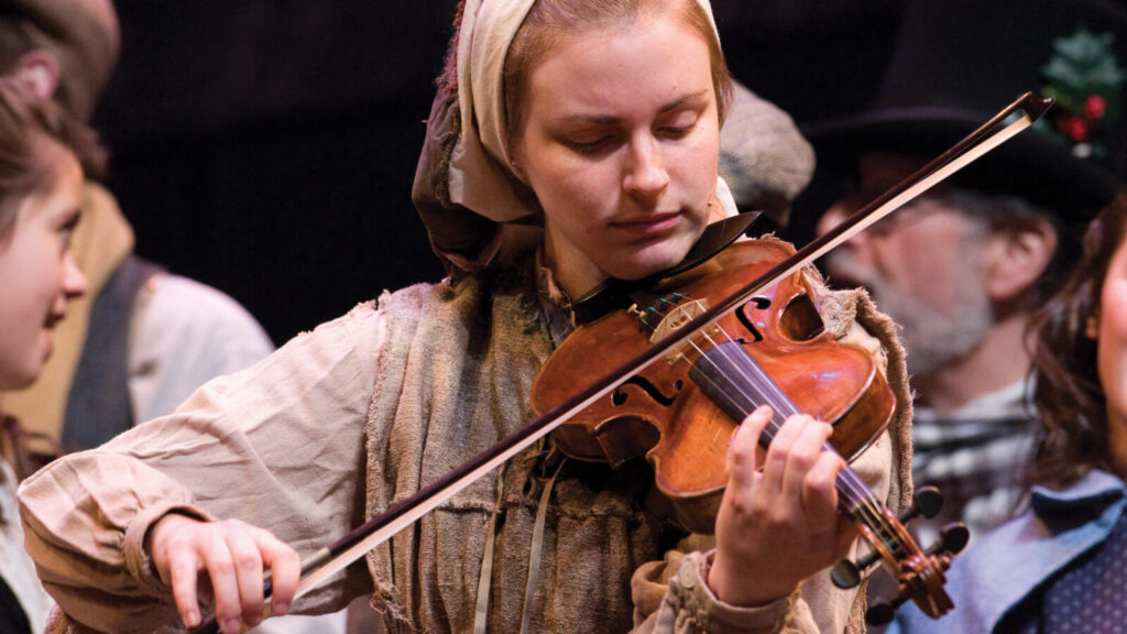 A violinist performs holiday music in Berkshire Theatre Group's 'A Christmas Carol.' Press photo courtesy of BTG