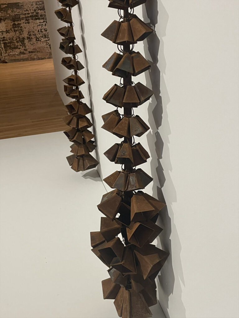 Cowbells hang from a yoke in in Cate O’Connell-Richards work in Like Magic at Mass MoCA.