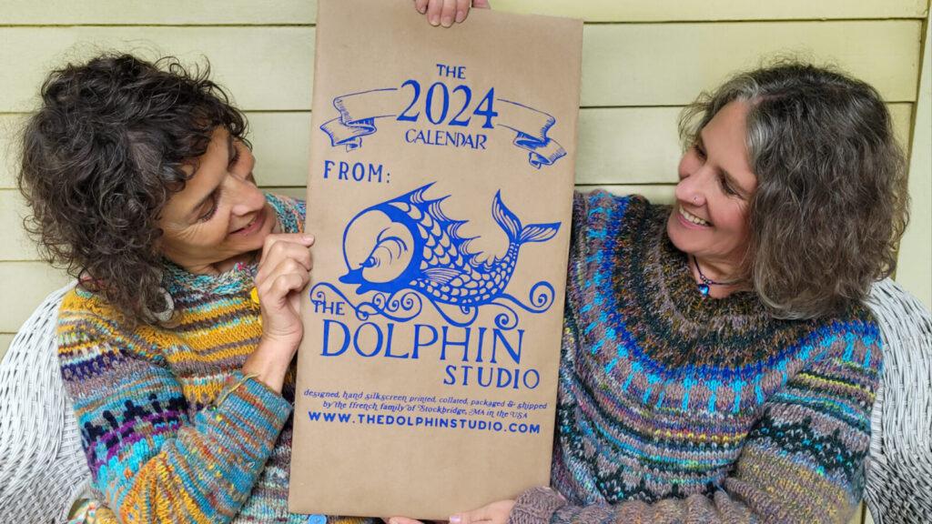 Crispina and Sofia ffrench sit holding the 2024 hand-printed silkscreen calendar from their Dolphin Studios in Stockbridge.