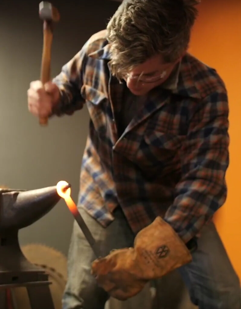 Blacksmith Benjamin Westbrook shapes hot iron on an anvil. Press photo courtesy of Hammer on Steel