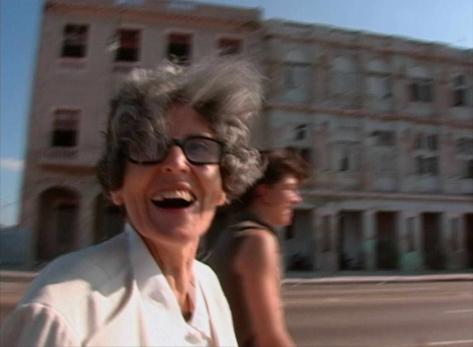 Maria Irene Fornés and filmmaker Michelle Memran grin broadly on a windblown street on the Malecon in Cuba in 2004