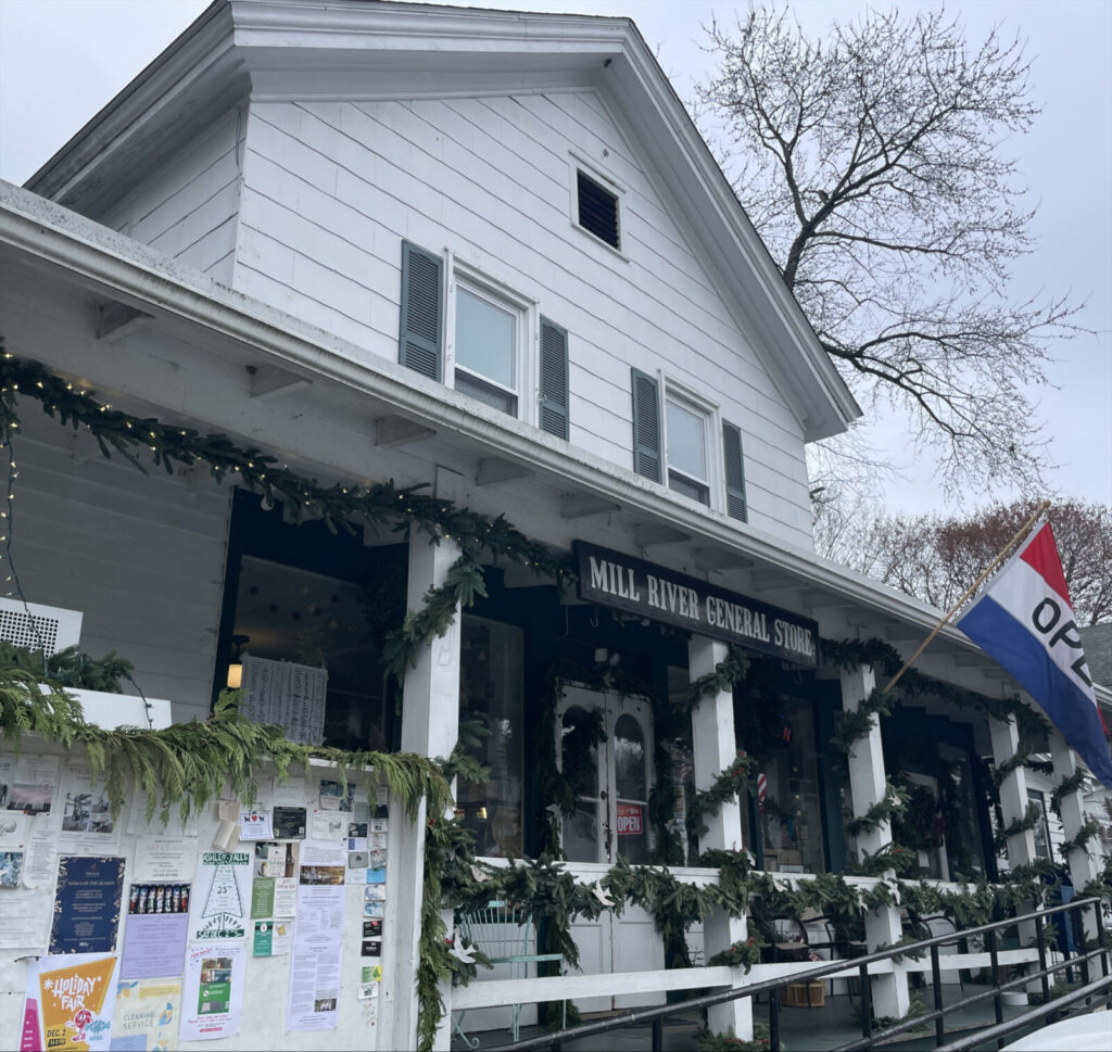 Mill River General store, an old clapboard building wound with green garlands for the holidays.