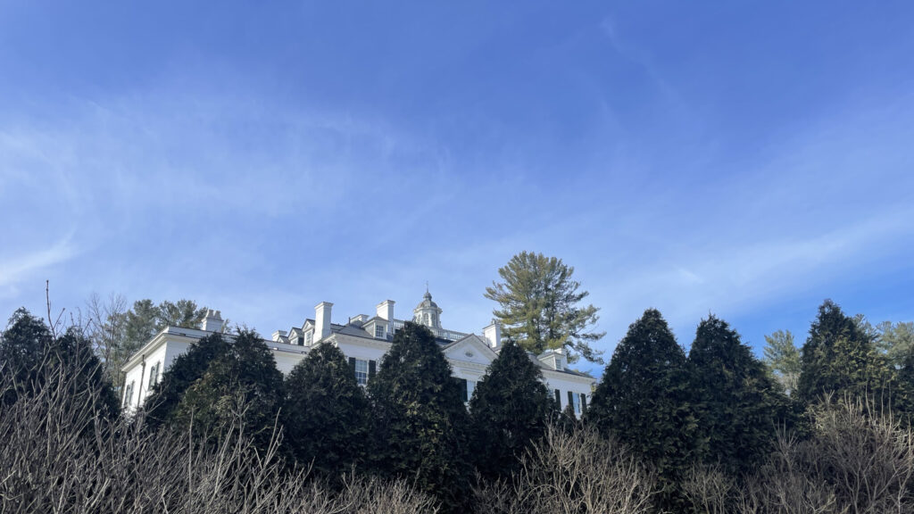 The Muont shows above peaks of evergreen in Edith Wharton's garden walk on a March morning.