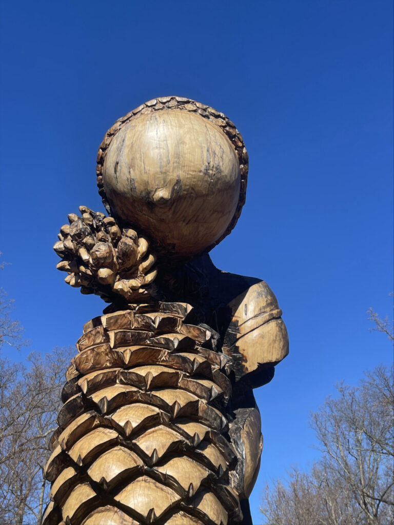 A wood sculpture forms a giant from carved pine cones at Brookside Gardens in Maryland.