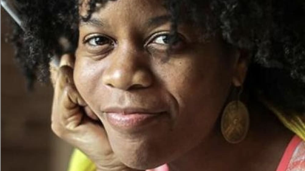 Acclaimed poet Ama Codjoe, winner of the Lenore Marshall Poetry Prize and finalist for the NAACP Image Award and the Paterson Poetry Prize, smiles with her chin in her hands. Press photo courtesy of Bard College at Simon's Rock