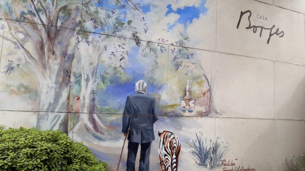 Jorge Luis Borges and a tiger walk side by side into a misted landscape in a mural at Casa Borges in Adrogue, Buenos Aires. Creative Commons courtesy photo from Travel Mag
