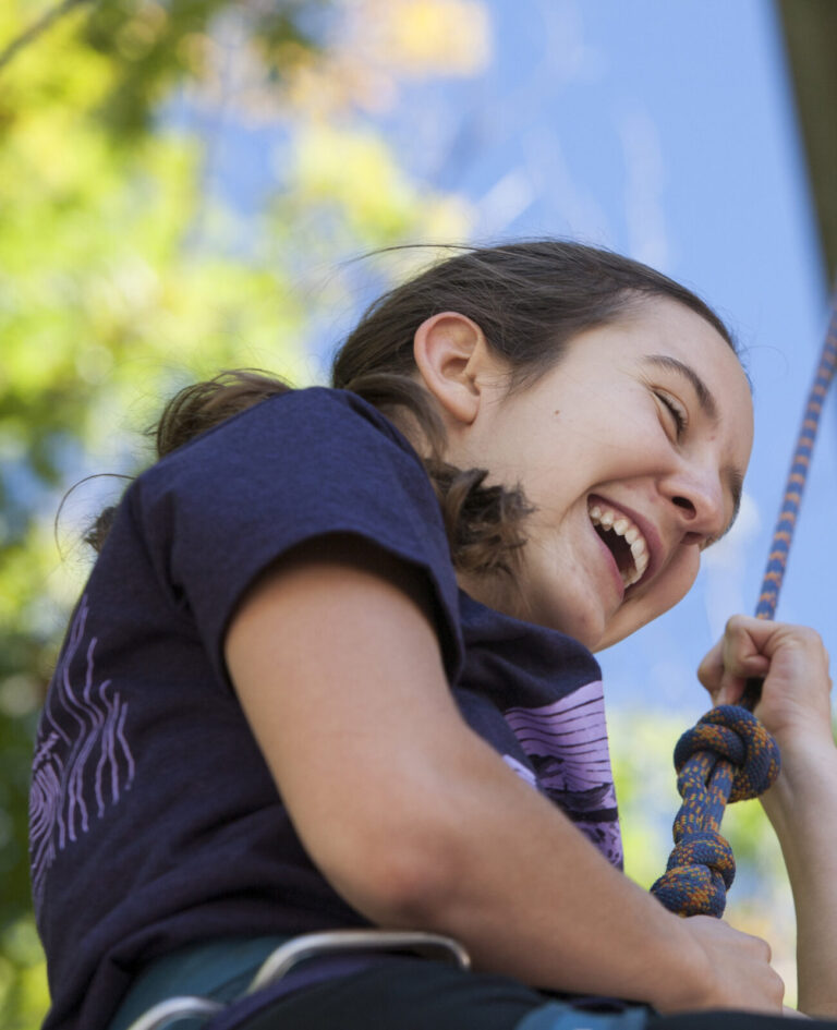 A student rappels from a college building on Mountain Day at Williams College. Students celebrate a fall day with music and outdoor activities.