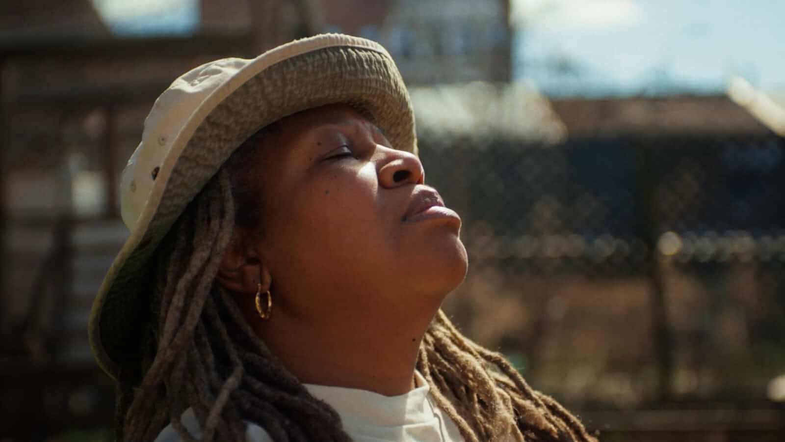 Karen Washington, farmer and activist and co-founder of the Black Farmer Fund, leans back in the sun in Fork in the Road, a documentary film about farming and food systems in the 21st century. Press photo courtesy of the filmmakers