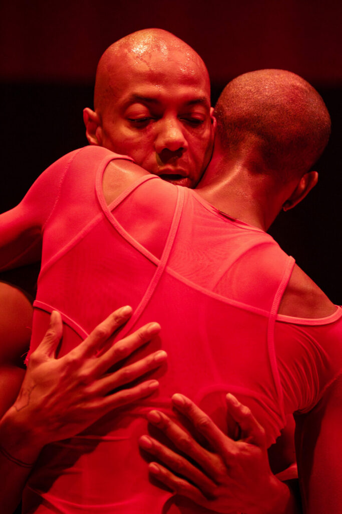 Shamel Pitts and Channce Williams hold one another in Touch of RED, created by the visionary arts collective TRIBE and choreographer Shamel Pitts. Press photo courtesy of Jacob's Pillow