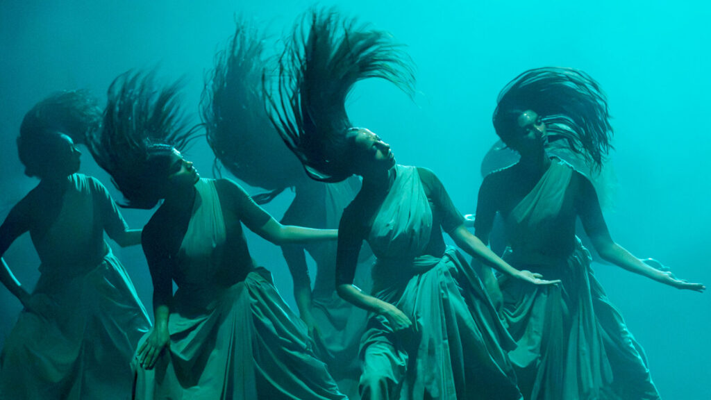 Company dancers fling their hair in waves as Akram Khan Company performs Thikra. Press photo courtesy of Jacob's Pillow