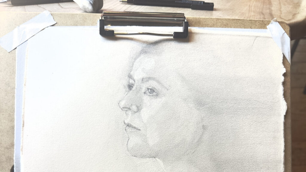 A figure drawing of a woman by Arthur Fredericks loks out of the page of a sketch pad. Photo courtesy of the artist.